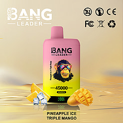 Promotional image of a Bang Leader vape device featuring 45000 puffs in Pineapple Ice Triple Mango flavor, with a playful chimp illustration, surrounded by mango slices, pineapple chunks, and ice cubes on a reflective golden surface.